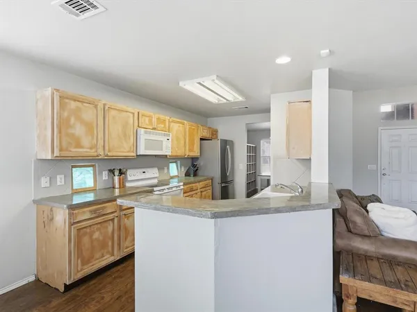 a kitchen with stainless steel appliances granite countertop a sink stove and cabinets