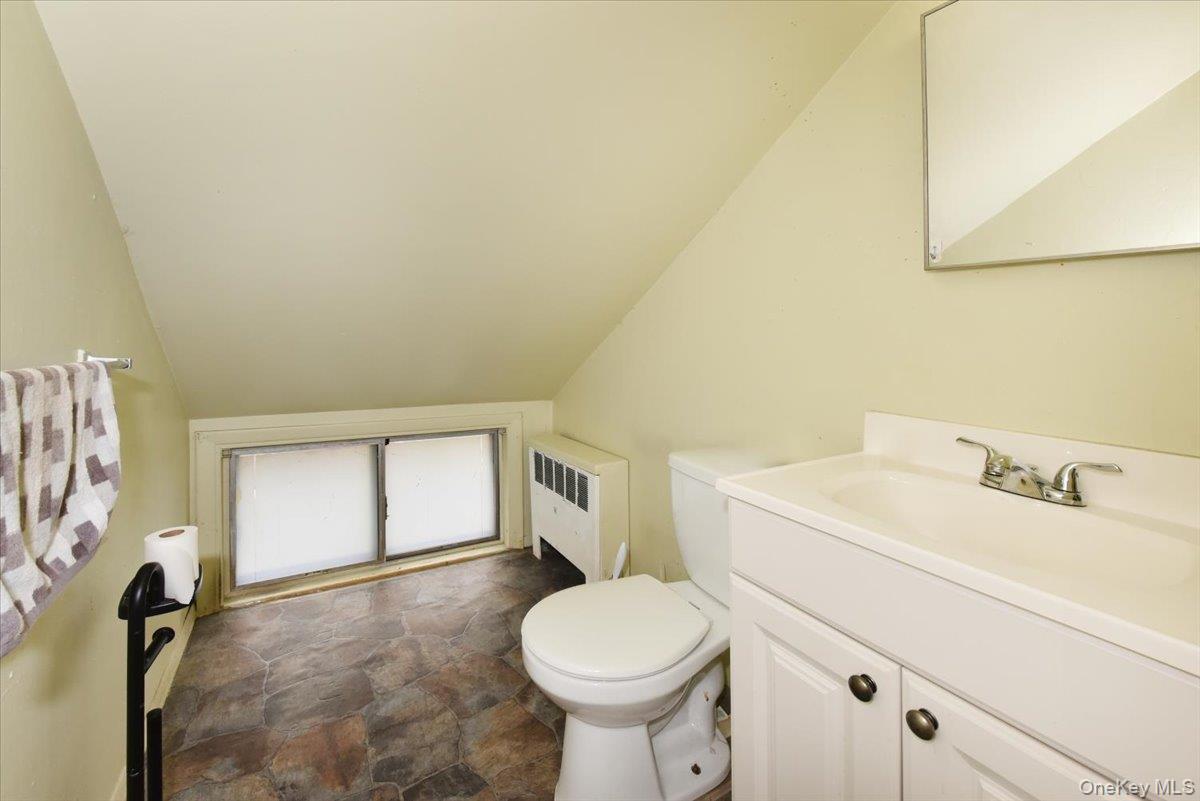 307 Blacksmith Road Levittown, NY 11756 - Photo 22 of 27 a bathroom with a sink toilet and vanity