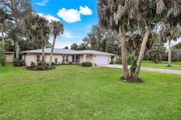 a front view of house with yard and green space