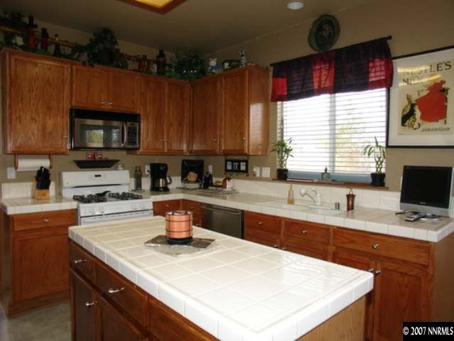 1445 Cayuse Way Reno, NV 89521 - Photo 3 of 9 a kitchen with a sink a stove and cabinets