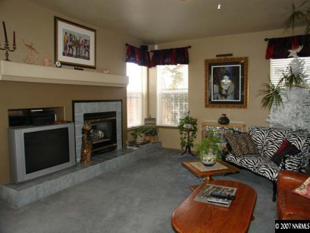 1445 Cayuse Way Reno, NV 89521 - Photo 5 of 9 a living room with furniture a window and a fireplace