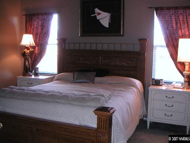 1445 Cayuse Way Reno, NV 89521 - Photo 6 of 9 a bedroom with a bed and a mirror