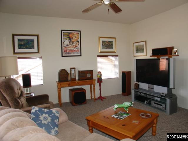 1445 Cayuse Way Reno, NV 89521 - Photo 8 of 9 a living room with furniture a flat screen tv and a fireplace