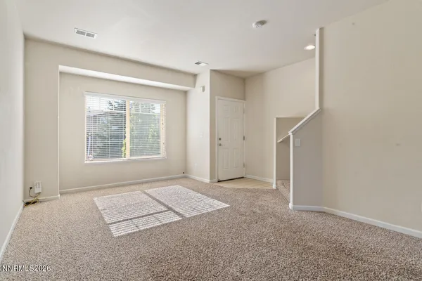 an empty room with windows and closet