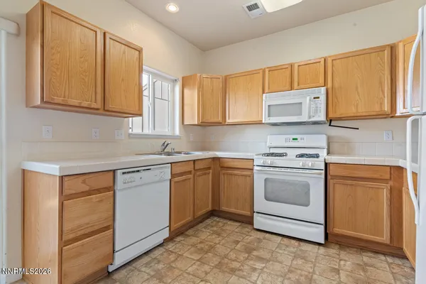 a kitchen with stainless steel appliances granite countertop a sink and cabinets