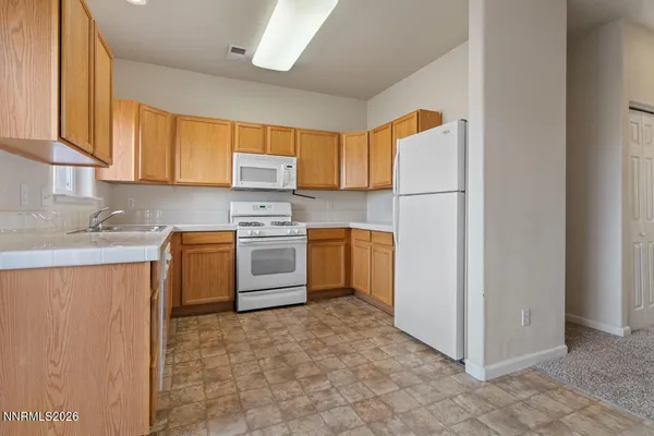 a kitchen with a white cabinets and white appliances