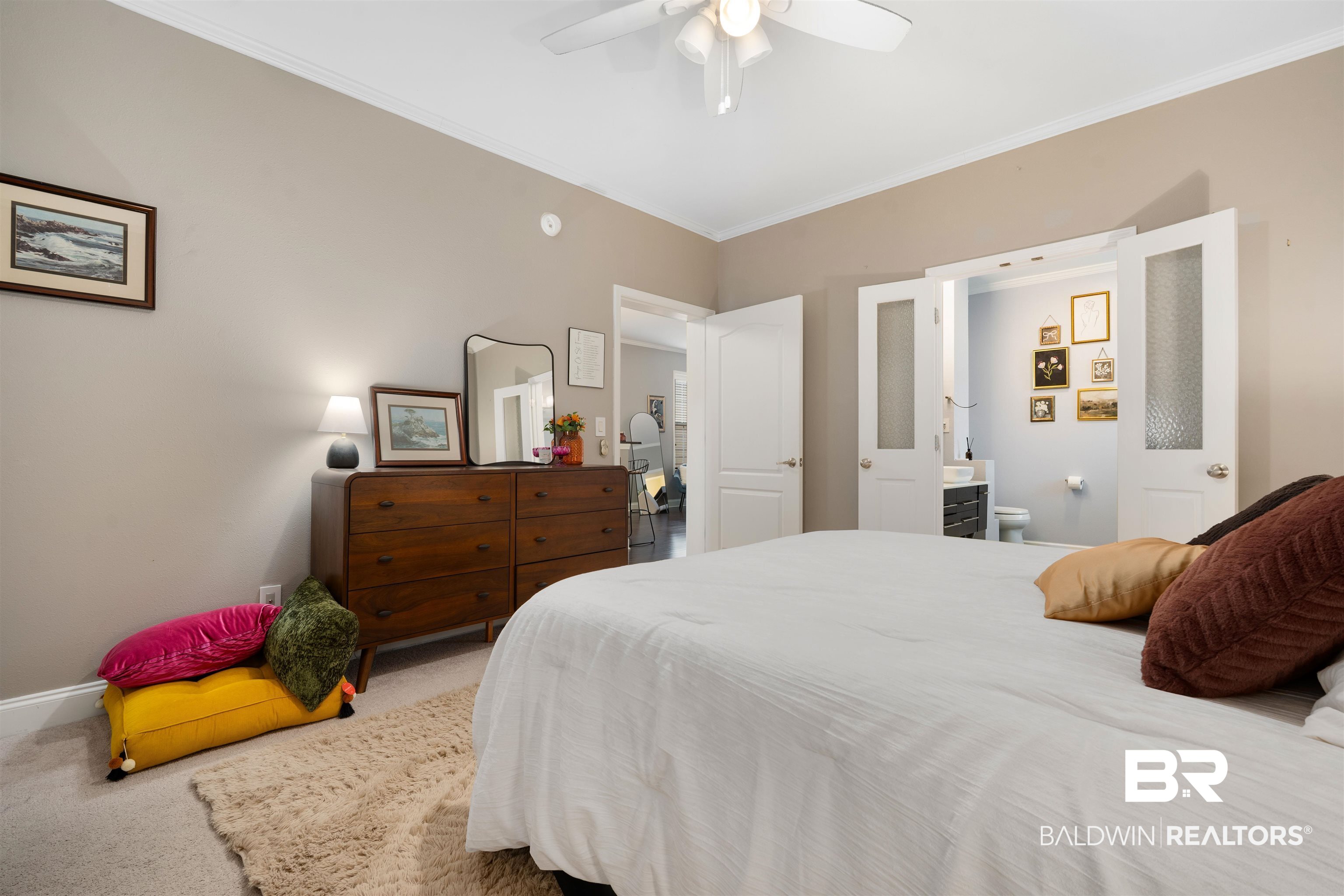 25806 Pollard Road, Unit 205 Daphne, AL 36526 - Photo 12 of 26 Bedroom featuring ornamental molding, carpet floors, ceiling fan, and connected bathroom