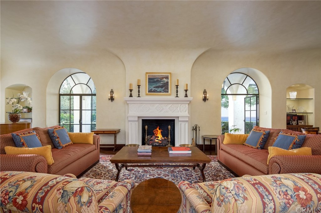 909 Vía Coronel Palos Verdes Estates, CA 90274 - Photo 19 of 59 a living room with a fireplace and a large window