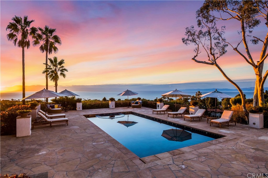 909 Vía Coronel Palos Verdes Estates, CA 90274 - Photo 58 of 59 a view of a swimming pool with lawn chairs under an umbrella