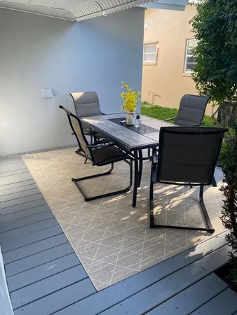 a balcony view with a seating space