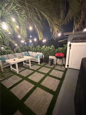 a view of a patio with table and chairs and potted plants