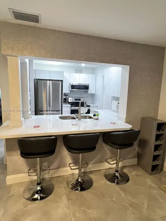 a kitchen with a sink cabinets and window