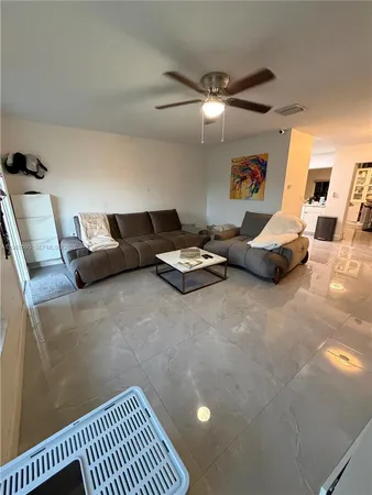 a bedroom with furniture and a large window