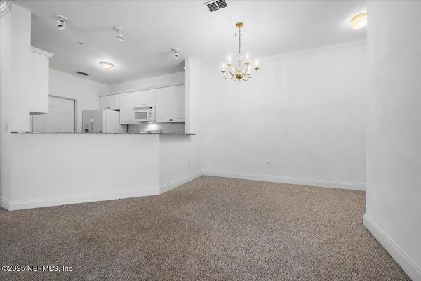 a view of a kitchen with kitchen island and wooden floor