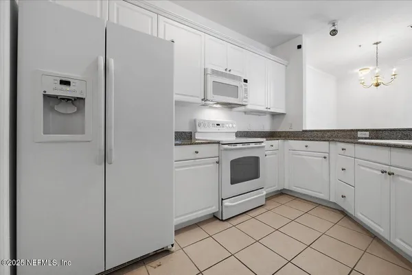 a kitchen with cabinets stainless steel appliances and sink