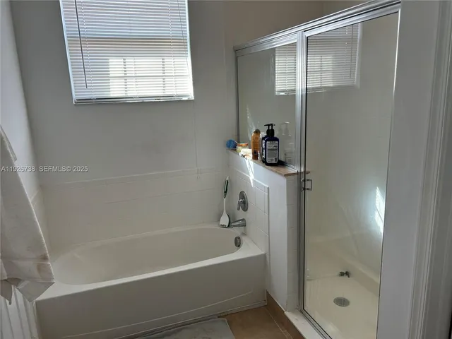a bathroom with a bathtub and a shower