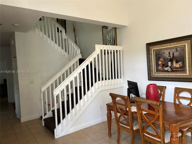 a view of a dining room with furniture and stairs