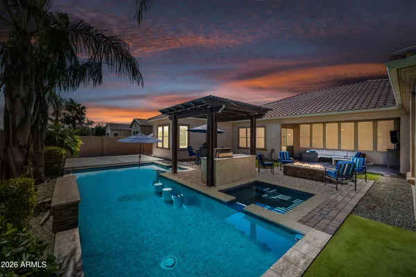 a view of a house with swimming pool and sitting area