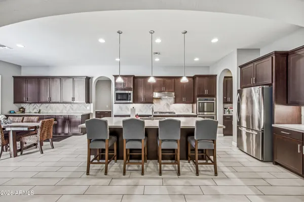 a large kitchen with a table and chairs
