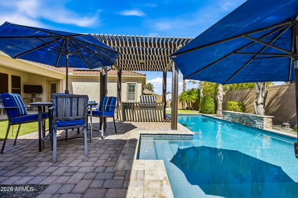 a view of a chairs and table in patio with a yard