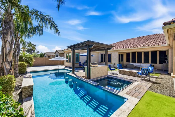 a spacious bathroom with a tub sink and mirror