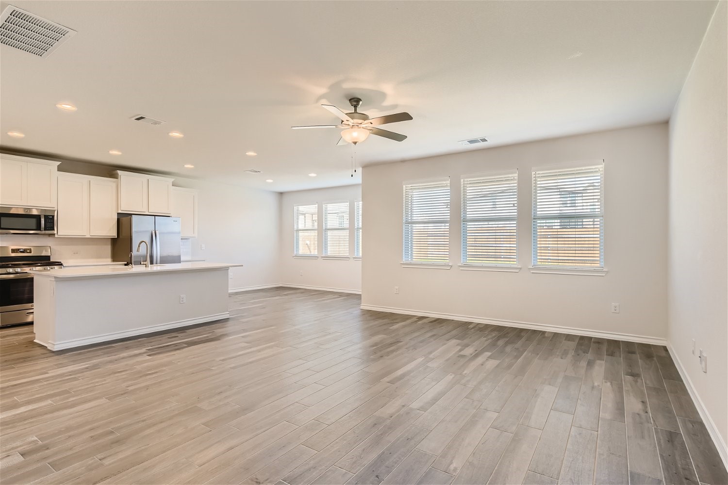 11612 Caithness Way Austin, TX 78754 - Photo 4 of 11 a view of kitchen with wooden floor and window