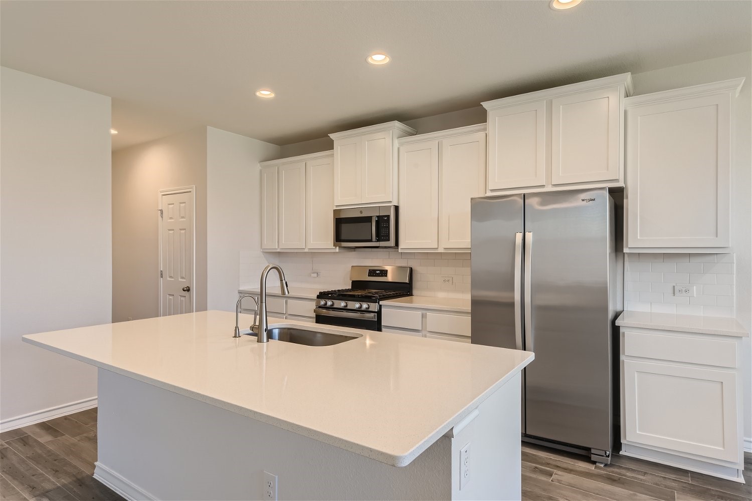 11612 Caithness Way Austin, TX 78754 - Photo 5 of 11 a kitchen with stainless steel appliances a refrigerator sink and microwave