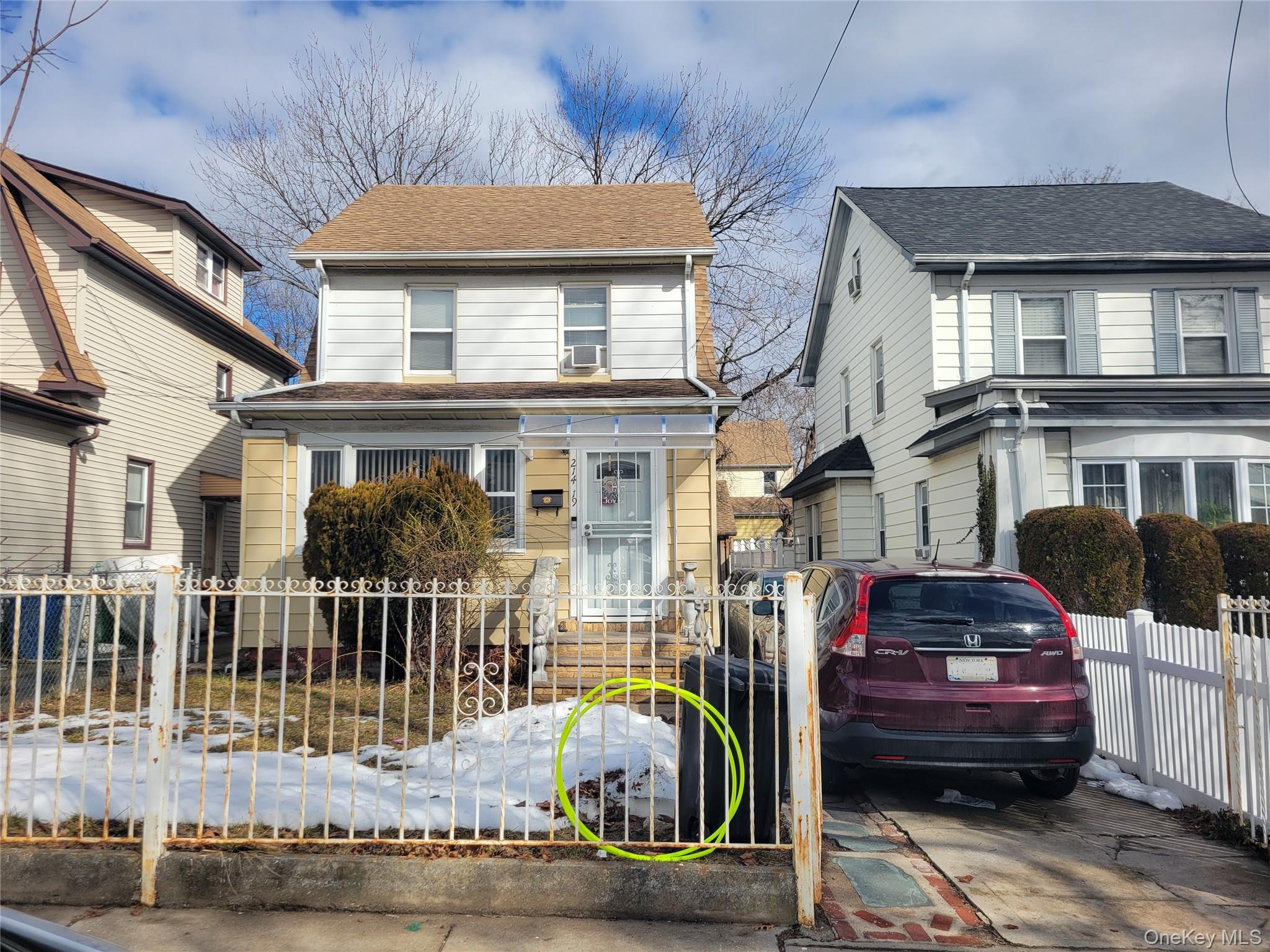 214-19 112th Road Queens, NY 11429 - Photo 1 of 19 a front view of a house with a iron gate