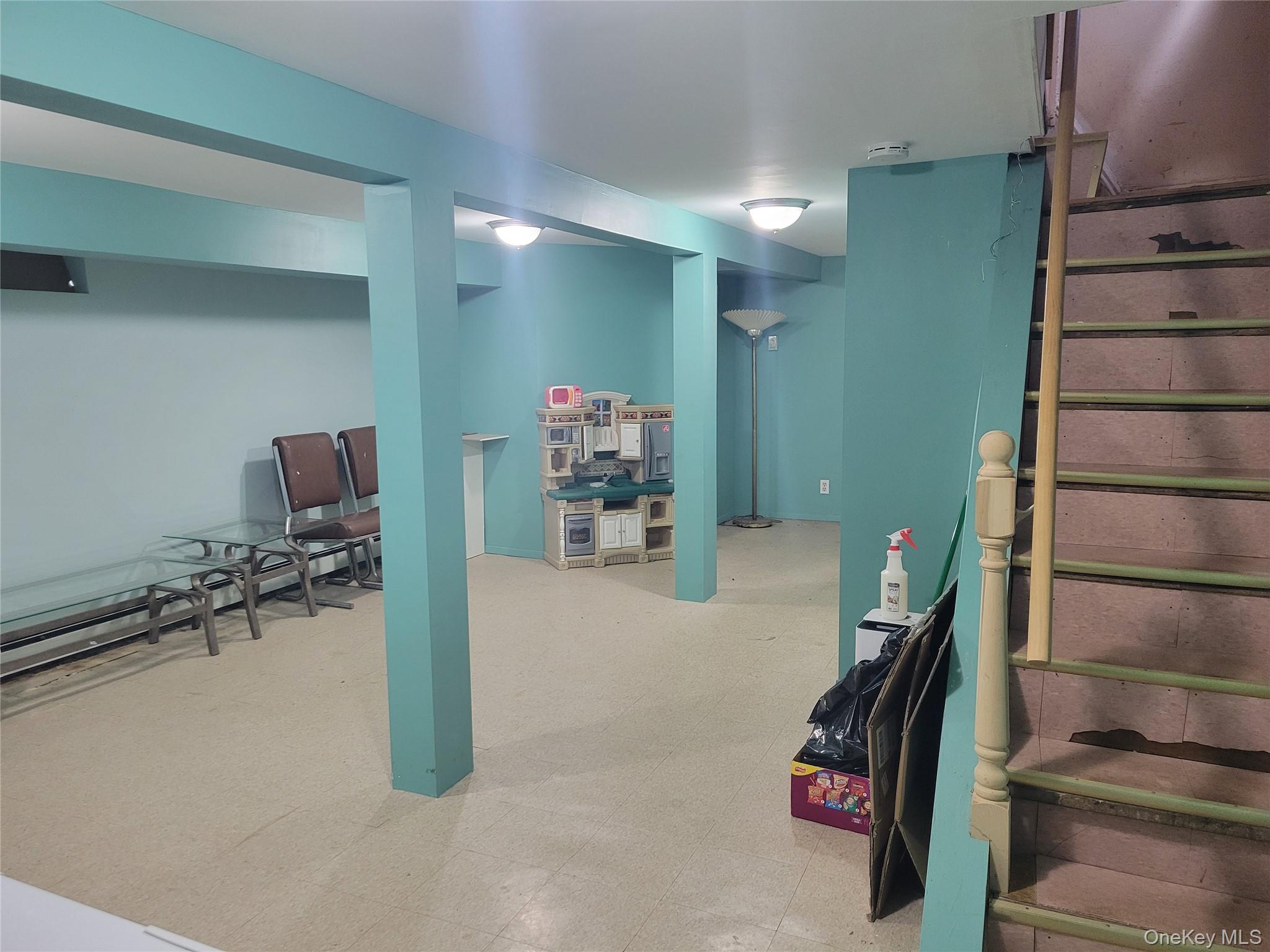 214-19 112th Road Queens, NY 11429 - Photo 11 of 19 a room with furniture and stairs