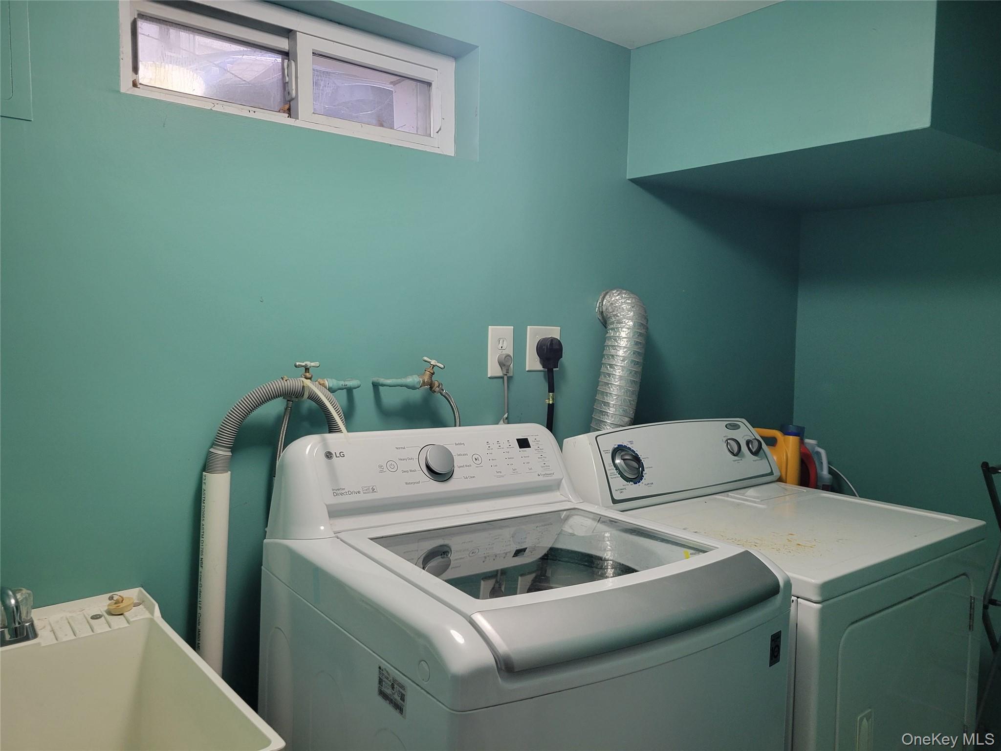 214-19 112th Road Queens, NY 11429 - Photo 12 of 19 a utility room with dryer and washer