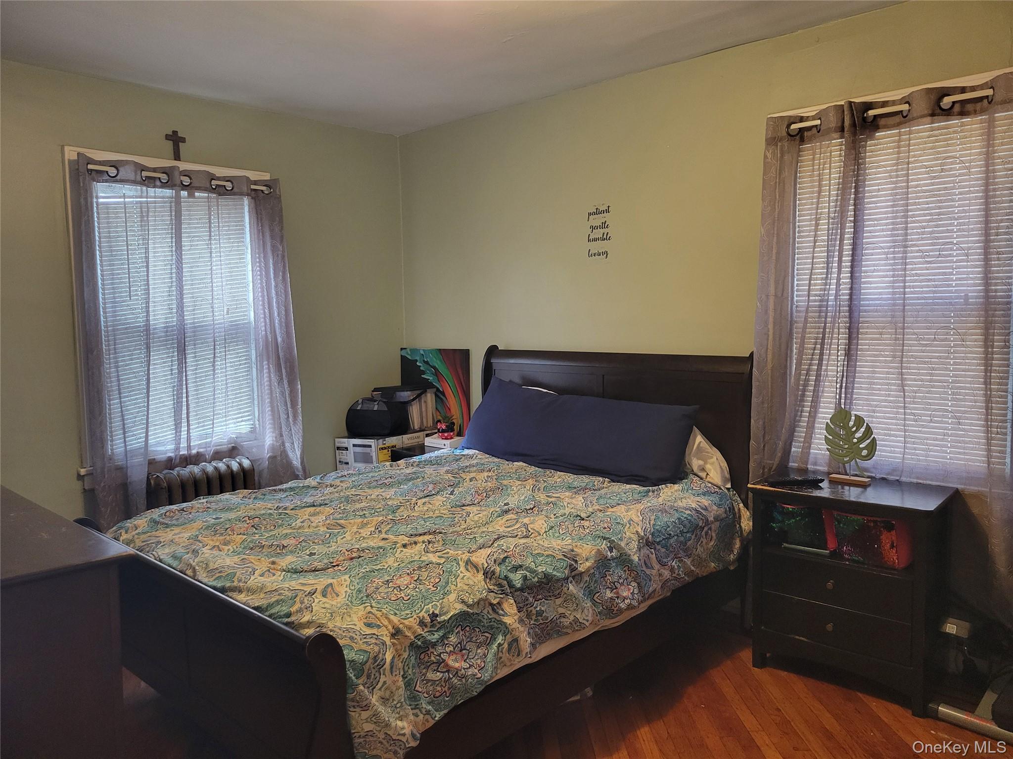 214-19 112th Road Queens, NY 11429 - Photo 13 of 19 a bedroom with a bed and a window