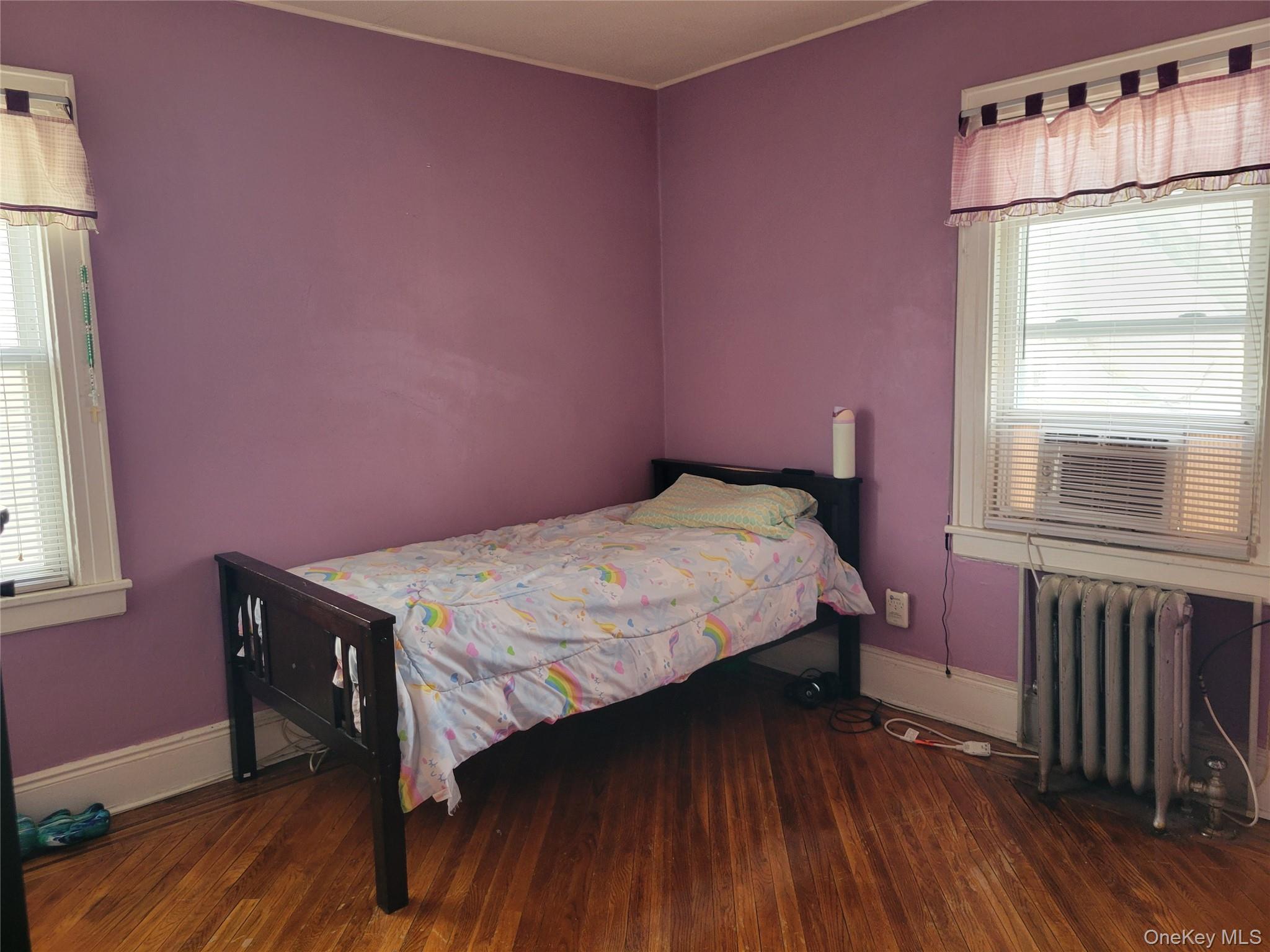 214-19 112th Road Queens, NY 11429 - Photo 14 of 19 a bedroom with a bed and a window