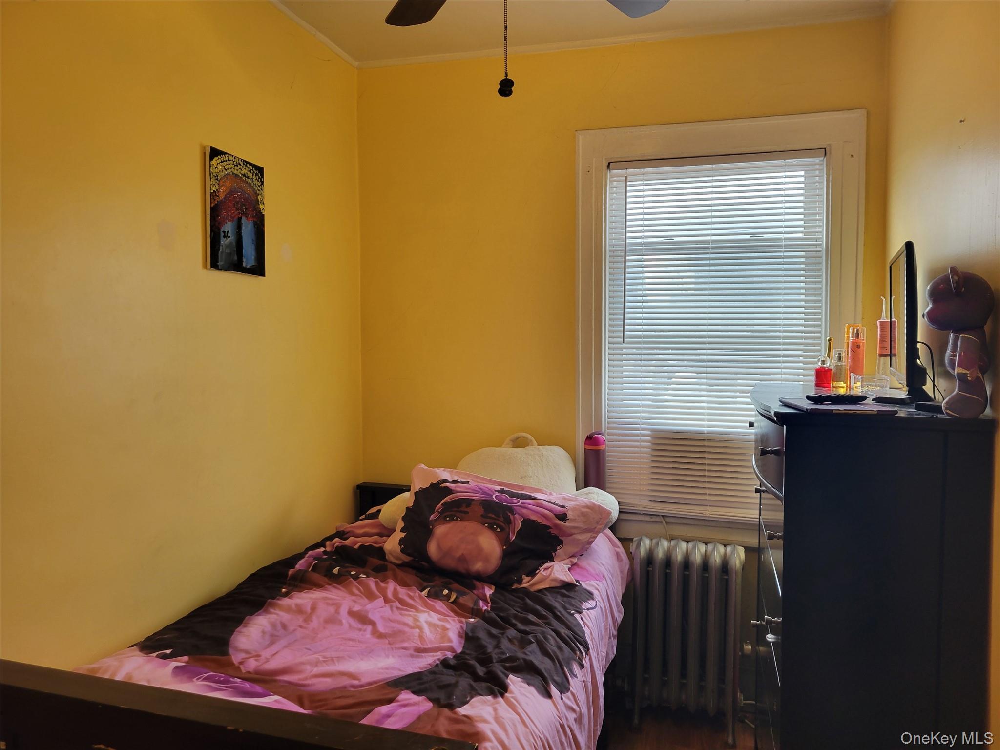 214-19 112th Road Queens, NY 11429 - Photo 15 of 19 a bedroom with a bed and wooden floor