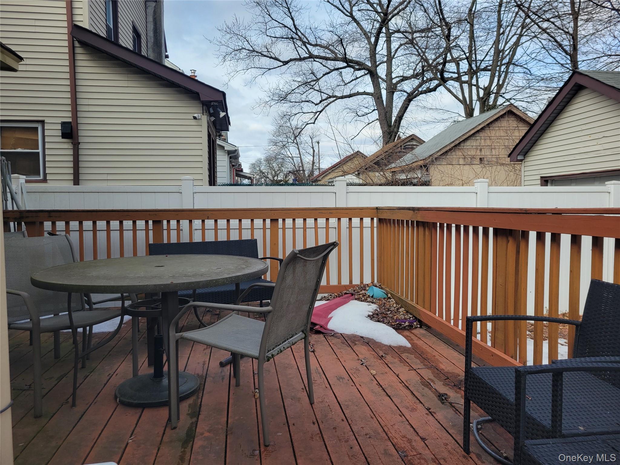 214-19 112th Road Queens, NY 11429 - Photo 16 of 19 a view of balcony with wooden floor and outdoor seating