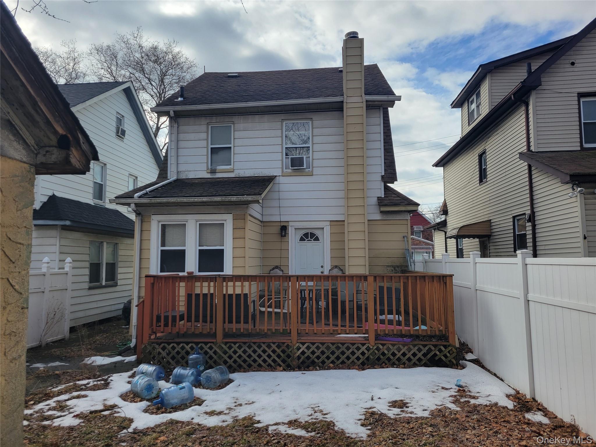 214-19 112th Road Queens, NY 11429 - Photo 18 of 19 a view of a house with a wooden fence