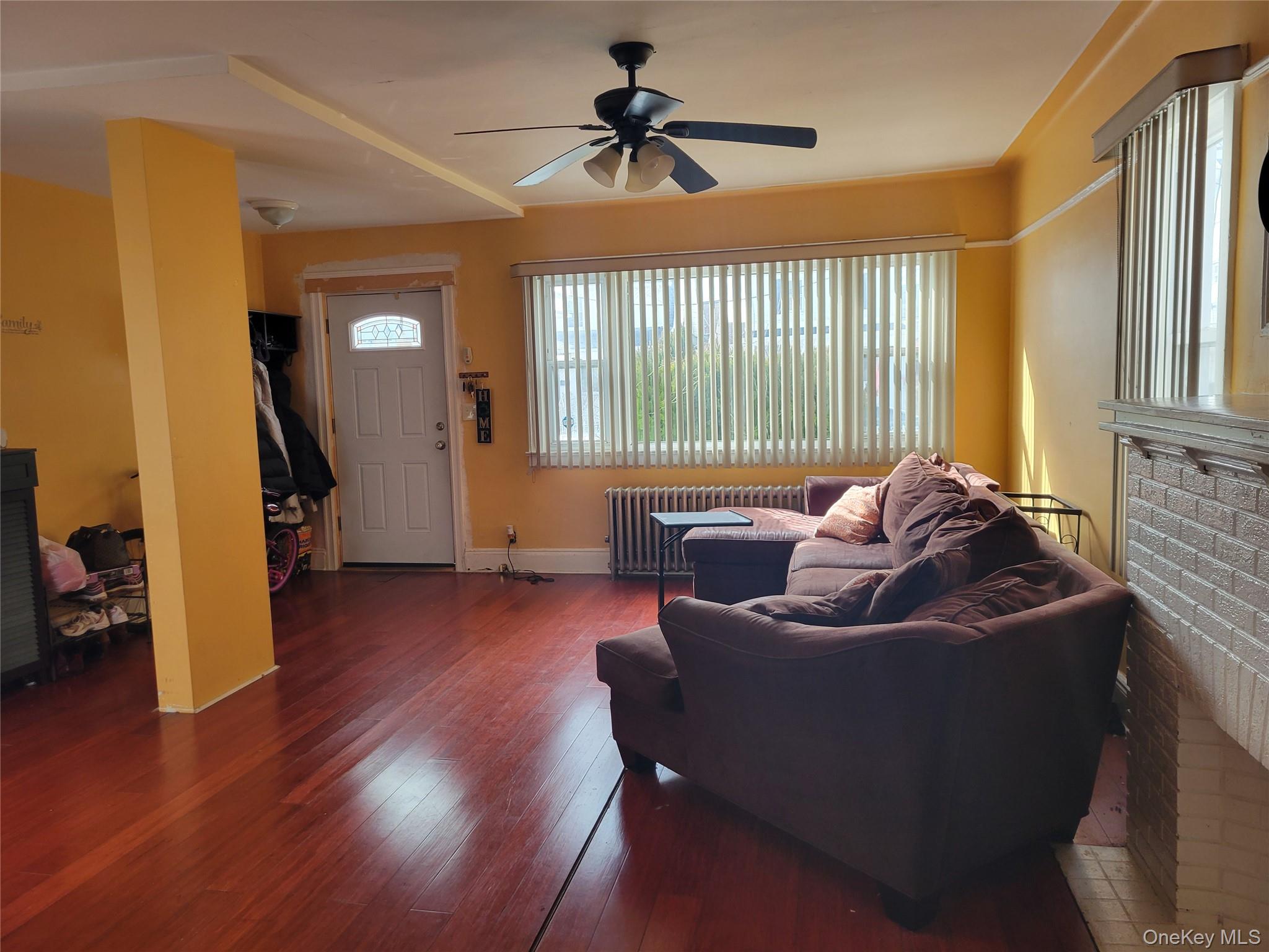 214-19 112th Road Queens, NY 11429 - Photo 4 of 19 a living room with furniture and a window