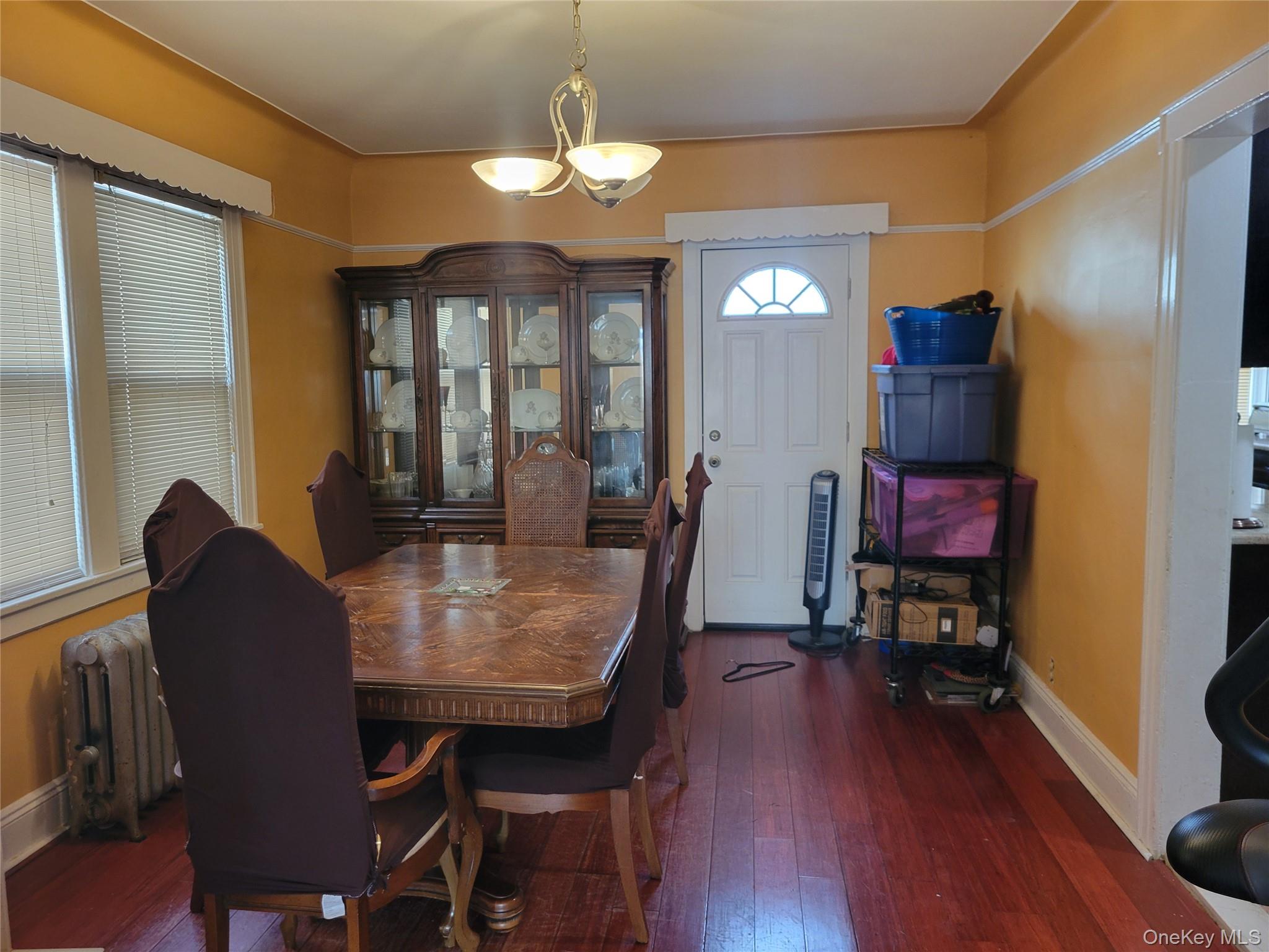 214-19 112th Road Queens, NY 11429 - Photo 5 of 19 a view of a dining room with furniture a chandelier and wooden floor