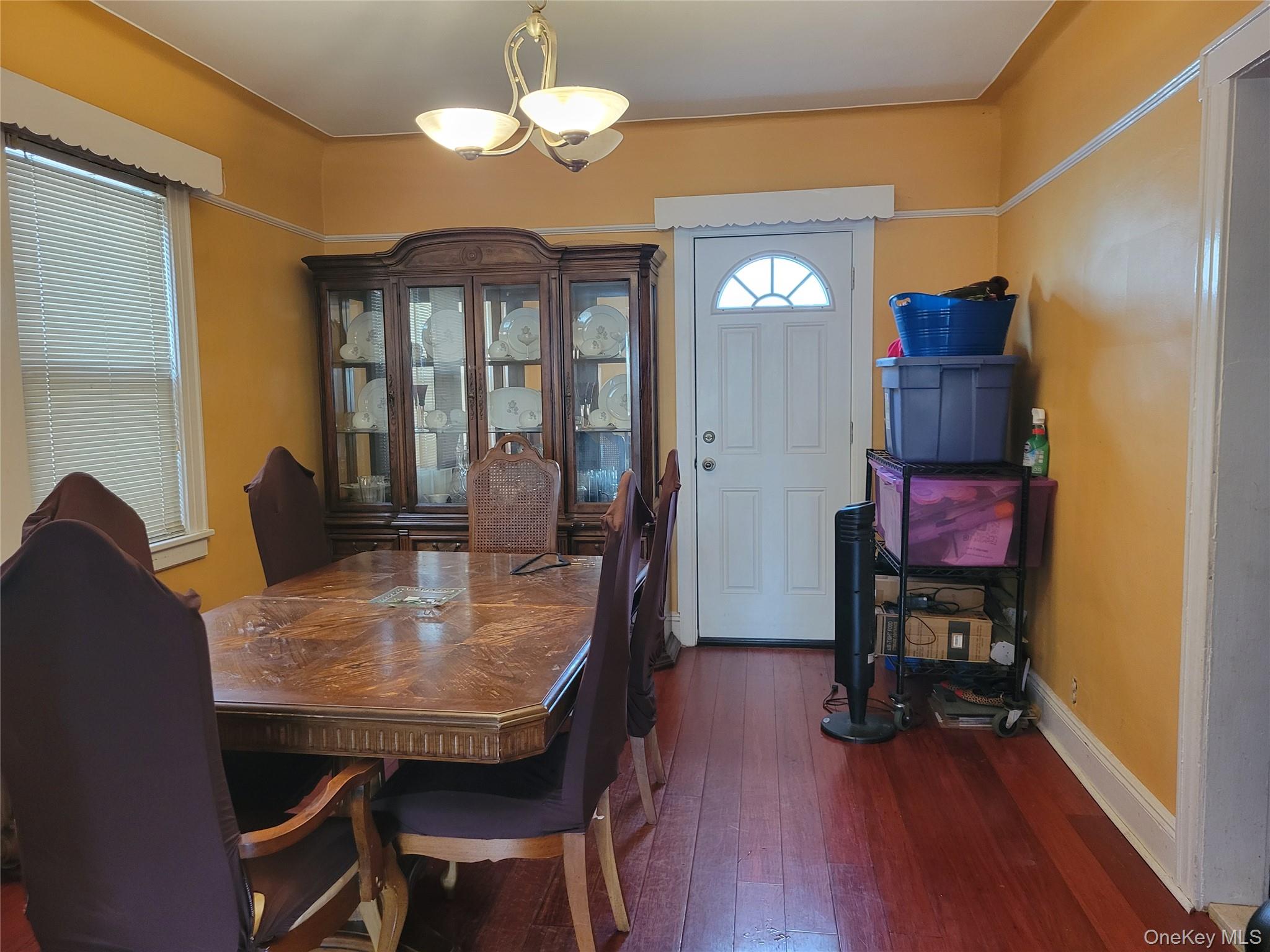 214-19 112th Road Queens, NY 11429 - Photo 6 of 19 a view of a dining room with furniture wooden floor and chandelier