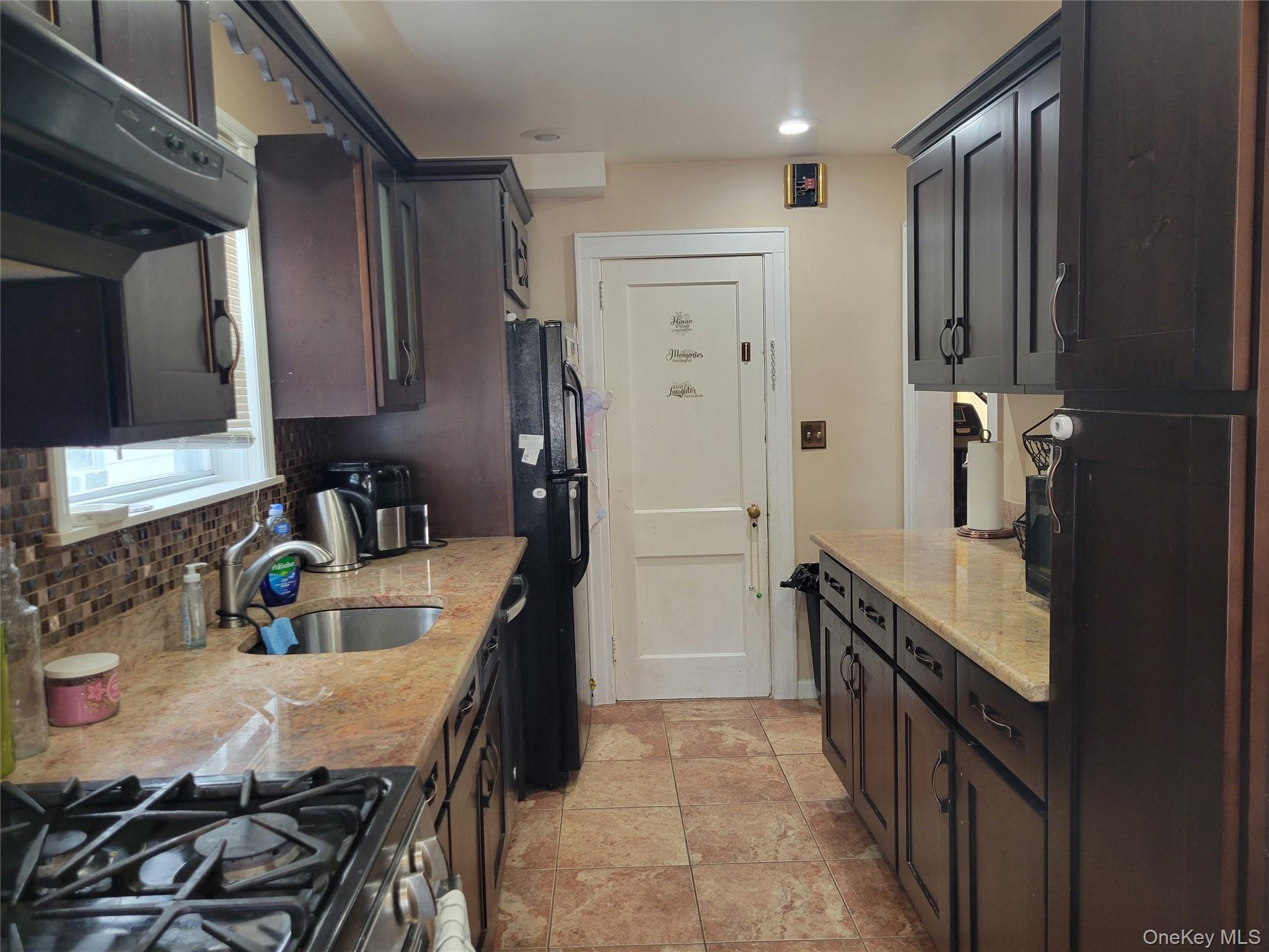 214-19 112th Road Queens, NY 11429 - Photo 8 of 19 a kitchen with stainless steel appliances granite countertop a sink stove and refrigerator