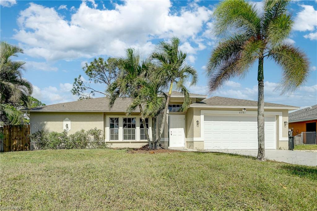 8381 Blackberry Road Fort Myers, FL 33967 - Photo 1 of 36 View of front of property featuring cooling unit, a front yard, and a garage