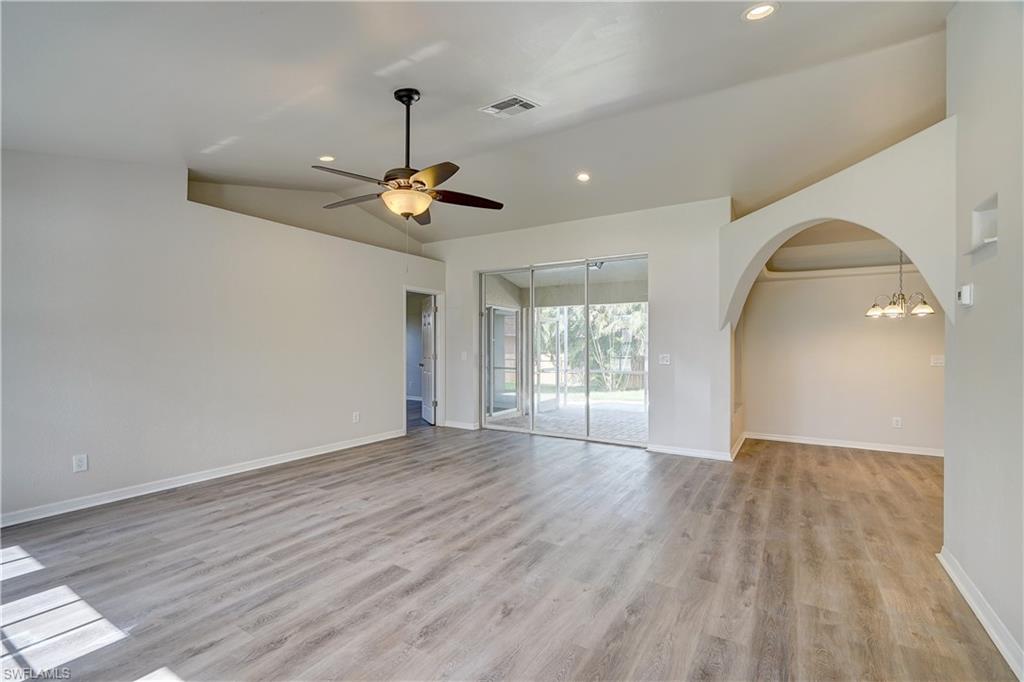 8381 Blackberry Road Fort Myers, FL 33967 - Photo 11 of 36 Spare room with vaulted ceiling, light hardwood / wood-style flooring, and ceiling fan with notable chandelier