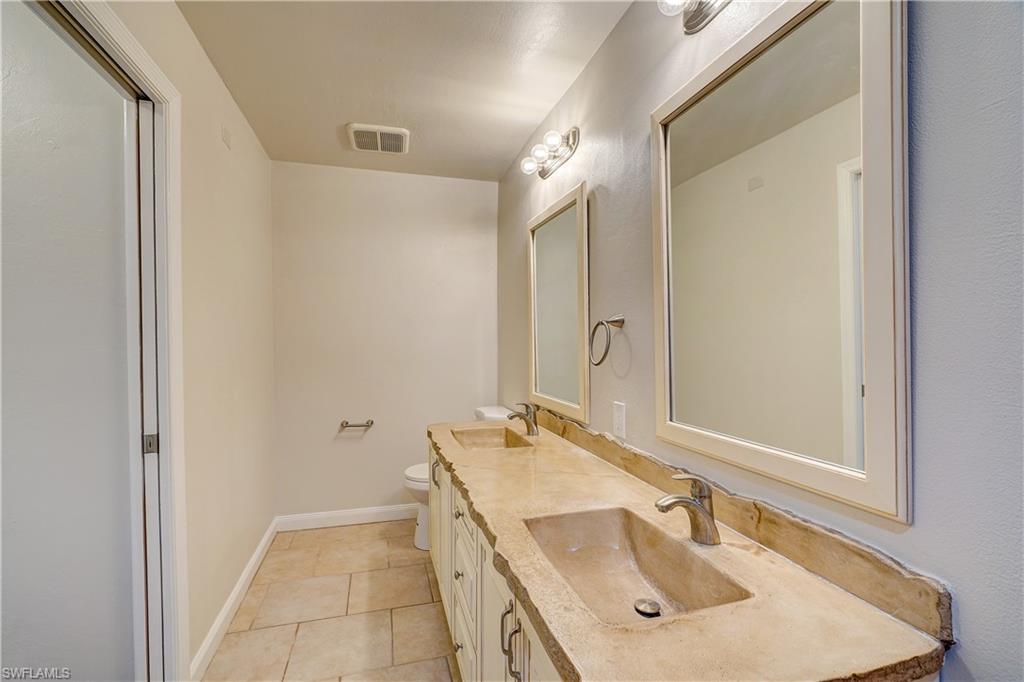 8381 Blackberry Road Fort Myers, FL 33967 - Photo 14 of 36 Bathroom with vanity, toilet, and tile patterned floors