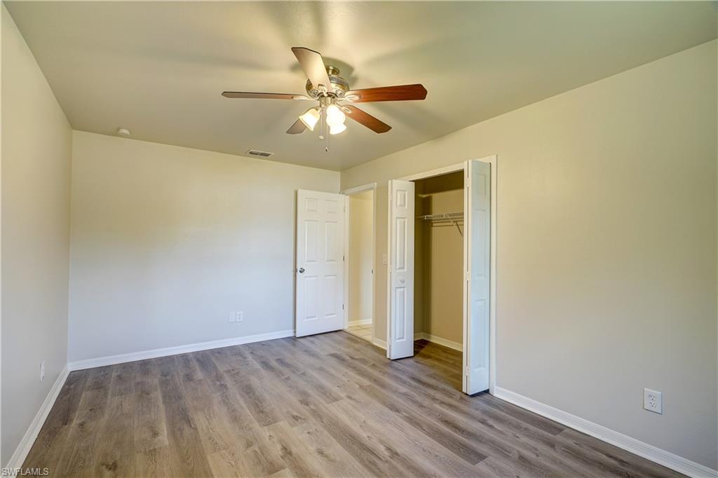 8381 Blackberry Road Fort Myers, FL 33967 - Photo 18 of 36 Unfurnished bedroom featuring a closet, ceiling fan, and light hardwood / wood-style floors