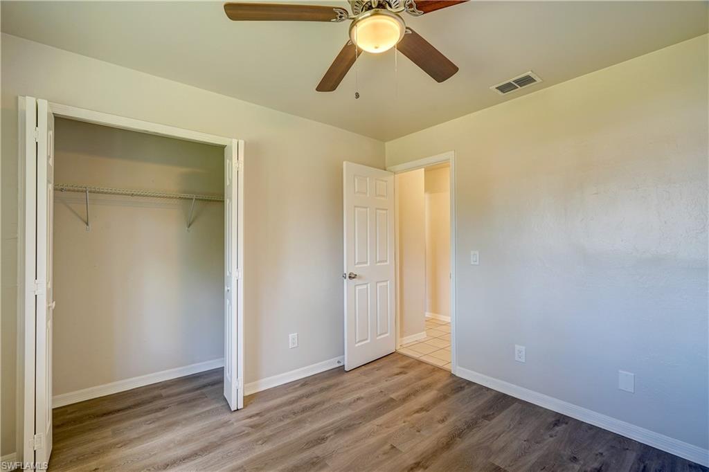 8381 Blackberry Road Fort Myers, FL 33967 - Photo 20 of 36 Unfurnished bedroom featuring a closet, hardwood / wood-style flooring, and ceiling fan