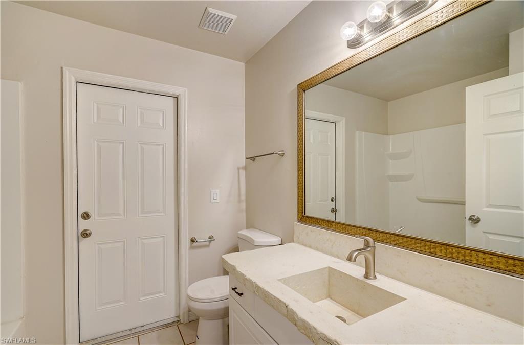 8381 Blackberry Road Fort Myers, FL 33967 - Photo 24 of 36 Bathroom with vanity, toilet, and tile patterned flooring