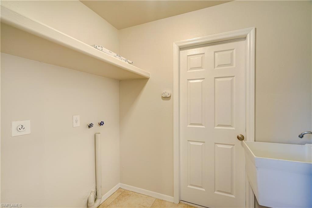 8381 Blackberry Road Fort Myers, FL 33967 - Photo 25 of 36 Clothes washing area with sink, electric dryer hookup, and light tile patterned floors