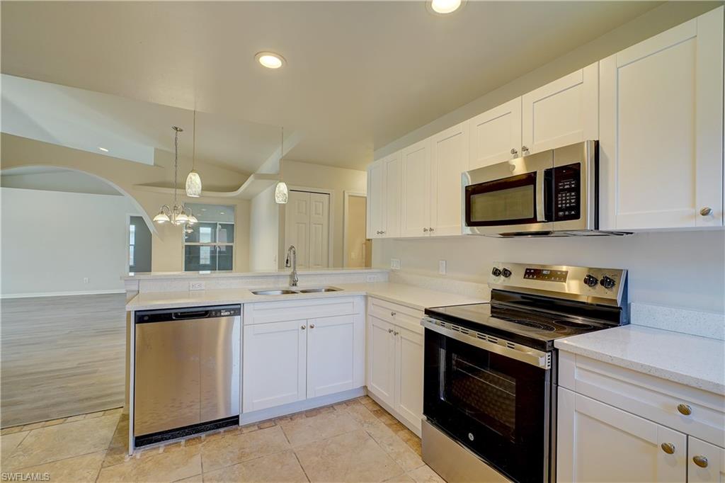 8381 Blackberry Road Fort Myers, FL 33967 - Photo 2 of 36 Kitchen with sink, white cabinets, light hardwood / wood-style flooring, and stainless steel appliances