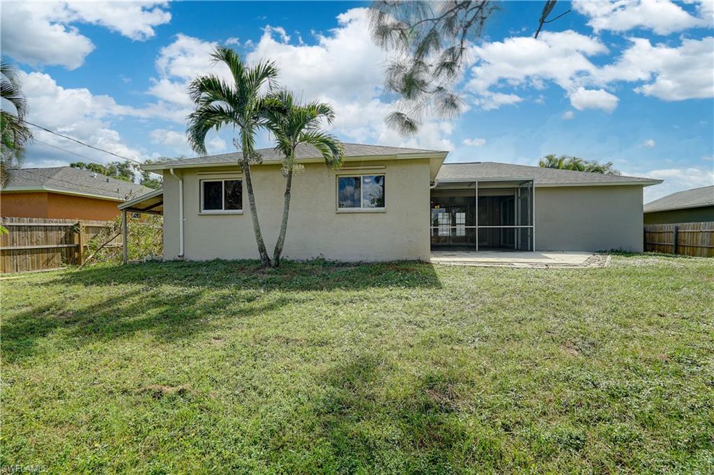 8381 Blackberry Road Fort Myers, FL 33967 - Photo 33 of 36 Back of house featuring a yard and a patio