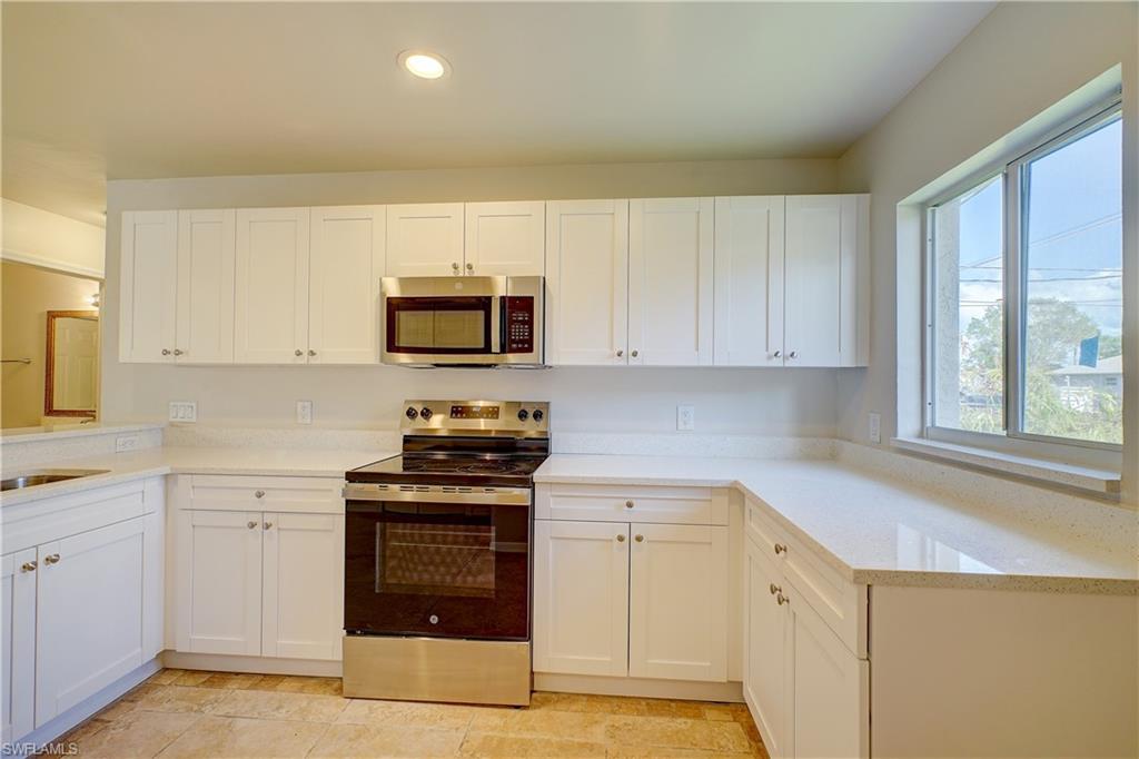 8381 Blackberry Road Fort Myers, FL 33967 - Photo 3 of 36 Kitchen featuring appliances with stainless steel finishes and white cabinetry