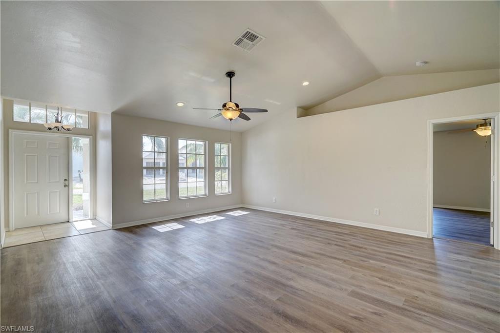 8381 Blackberry Road Fort Myers, FL 33967 - Photo 8 of 36 Foyer entrance with vaulted ceiling, wood-type flooring, and ceiling fan with notable chandelier